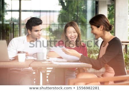 Foto stock: Business Team Working Happily Together On Laptop