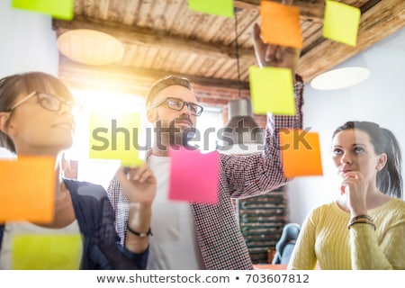 Foto stock: Team Brainstorming With Sticky Notes