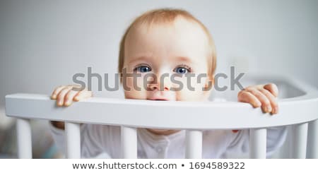 Сток-фото: Baby Girl Sit On White Sheet On The Bedroom