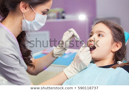 Stock photo: Dentist Treating Kid Teeth At Dental Clinic