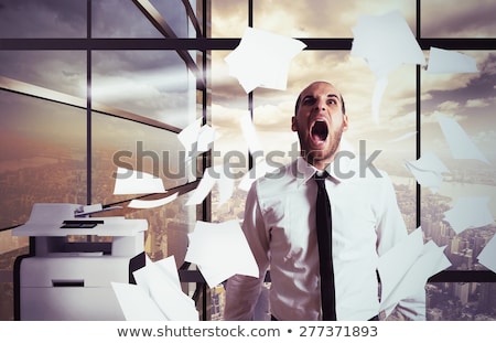 Stockfoto: Businessman Stressed And Overworked Screaming In Office With Flying Paper Sheets