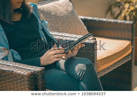 Foto stock: Beautiful Woman Using Ebook Reader In A Cafe