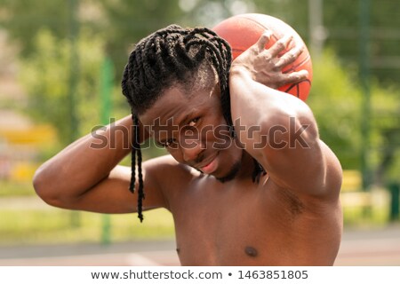 Foto d'archivio: Young Successful Shirtless Basketballer Holding Ball Behind Neck