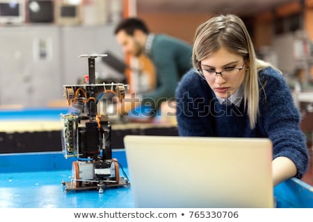 Сток-фото: The Young Technician Repairing Computer In Workshop