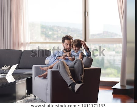 Stok fotoğraf: Father And Daughter With Tablet Computers At Home