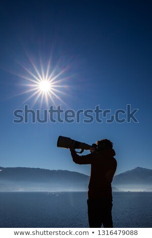 Foto stock: Young Man Devoting Time To His Favorite Hobby - Photography