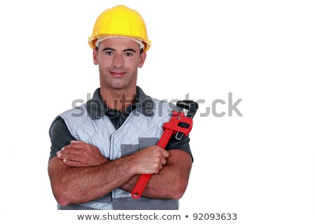 [[stock_photo]]: Portrait Of Tradesman Cross Armed Holding Adjustable Spanner