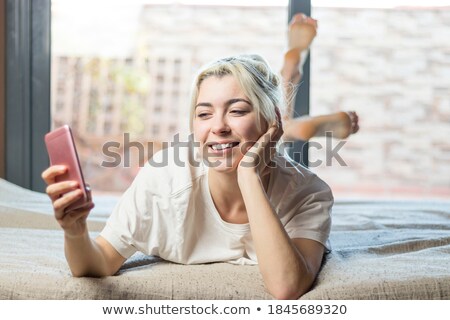 Gorgeous Blond Woman Lying On Her Bed Stockfoto © 2Design