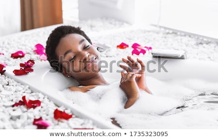 Stock photo: Smiling Woman Enjoying A Relaxing Bubble Bath