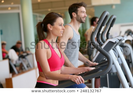 Foto d'archivio: Athletic Man And Woman Doing Cardio Training Program In Fitness