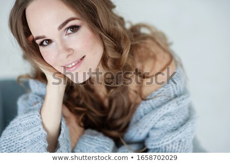 Foto d'archivio: A Girl In Blue Clothes Is Sitting On A Blue Background