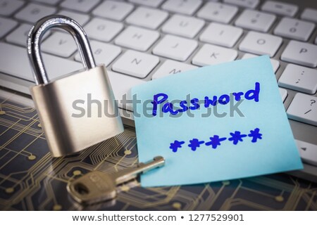 Stok fotoğraf: Padlock And Password Note On Circuit Board Keyboard