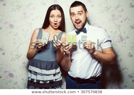 A Pregnancy And People Concept Happy Man Pregnant Woman At Home Clothes Looking Stock photo © Augustino