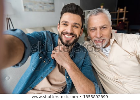 Stockfoto: Father And Son Taking Selfie At Home