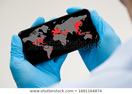 Foto d'archivio: Checking Coronavirus Infection Map On Phone