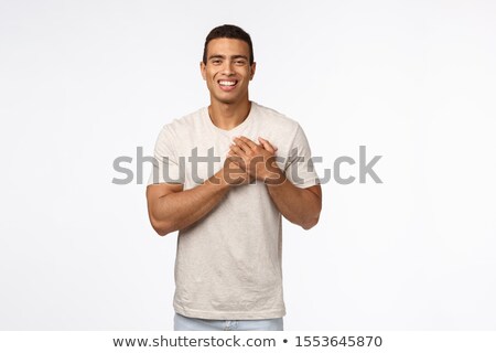 Foto stock: Guy Feeling Touched And Flattered Receiving Praises Charming Hispanic Young Man In T Shirt Press H