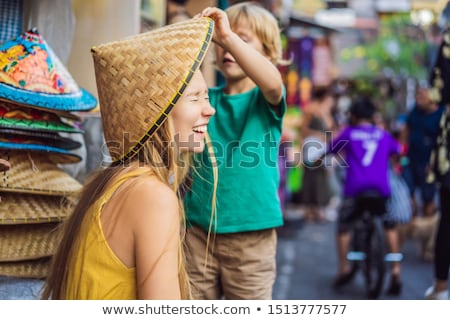 Foto stock: Mom And Son Travelers Choose Souvenirs In The Market At Ubud In Bali Indonesia Banner Long Format