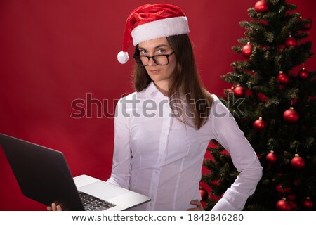 Stockfoto: Young Beautiful Woman Holding Tip Of Santas Hat