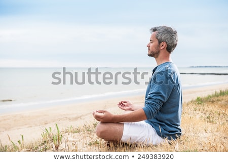 Stock photo: Man On The Beach Meditating