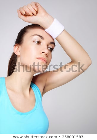 [[stock_photo]]: Tennis Player Wiping The Sweat From His Brow