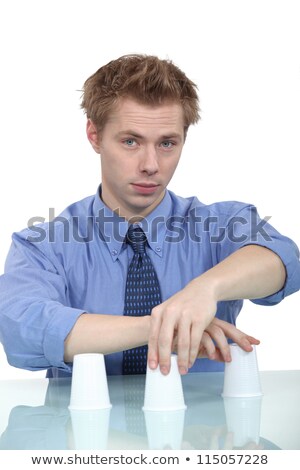 Stok fotoğraf: A Businessman Doing A Cup Trick