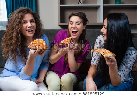 Stok fotoğraf: Three Friends Eating While Watching Television