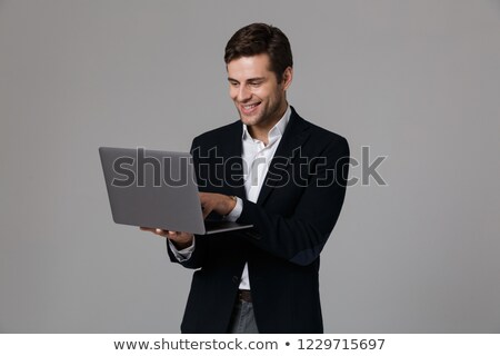 ストックフォト: Image Of Young Businessman 30s In Suit Rejoicing While Using Lap