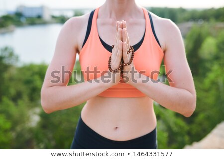 Foto stock: Making Namaste Gesture With Mala Beads