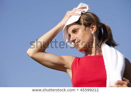 Stock fotó: A Woman Cleaning Her Sweat With A Towel