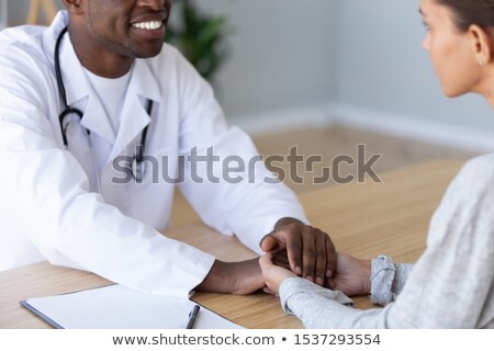 Stok fotoğraf: Doctor Comforting Patient At Table