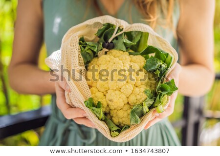 Foto stock: Cauliflower In A Reusable Bag In The Hands Of A Young Woman Zero Waste Concept