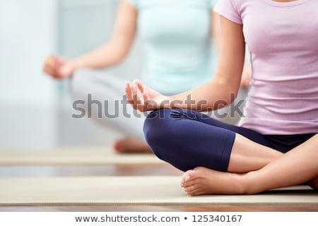 Foto stock: Relaxed Young Woman Exercising In Lotus Position