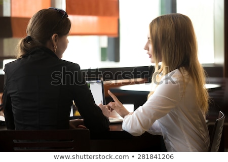 Сток-фото: Back View Of Two Women Working By The Table