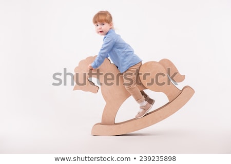 Stockfoto: A Young Girl On A Rocking Horse