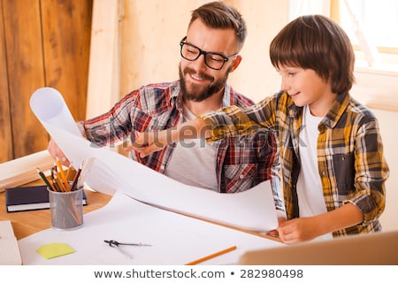 Stok fotoğraf: Happy Father And Son With Blueprint At Workshop