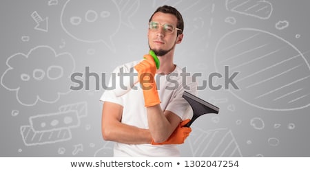 Foto stock: Male Housekeeper With Grey Doodled Wallpaper