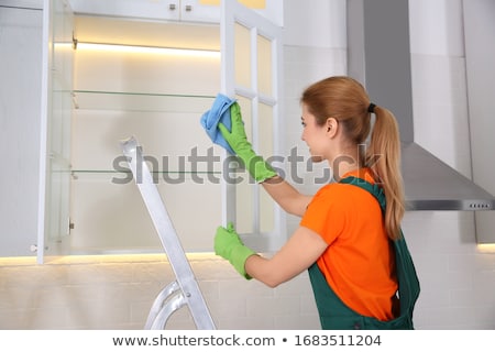 Stock photo: Janitor Cleaning Shelf With Napkin