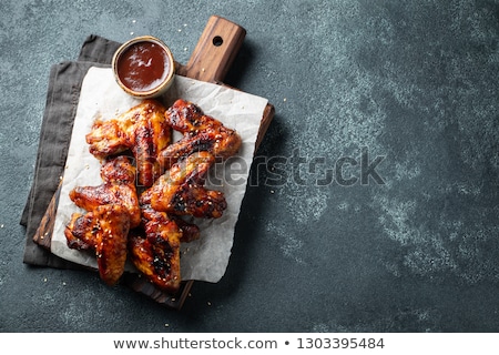 Foto stock: Hot And Spicy Chicken Wings On Dark Background