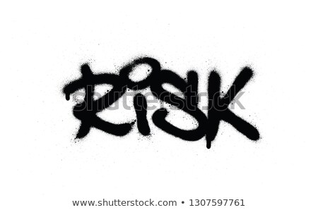 Foto d'archivio: Graffiti Risk Word Sprayed In Black Over White