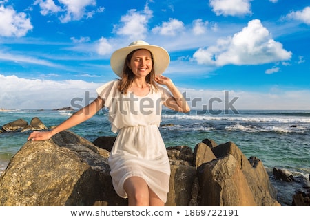 Сток-фото: Portrait Of A Girl Near The Sea Sitting On The Rocks With A Toy Ship In Hands