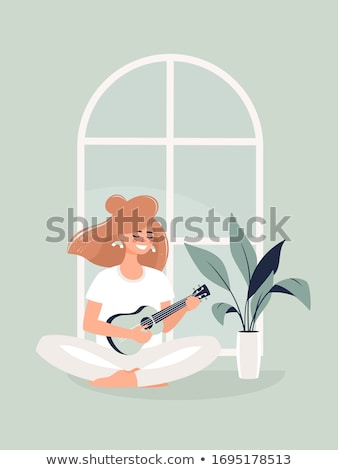 Foto stock: Young Woman Playing Guitar