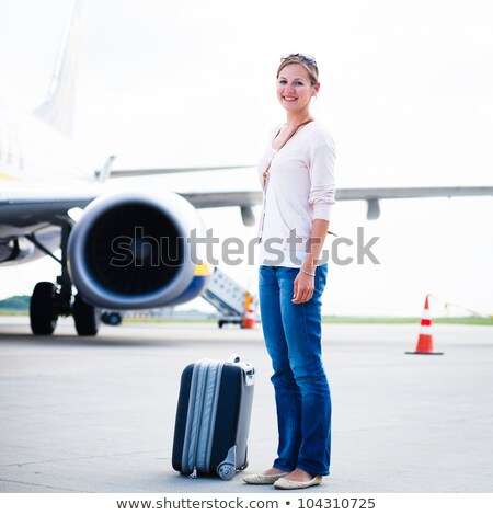 Stock fotó: Young Woman At An Airport Having Just Left The Aircraft