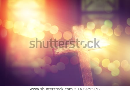 Foto stock: Crucifix In Church Under Stained Glass Window