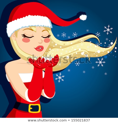 Foto stock: Woman With Santa Hat Blows The Stars