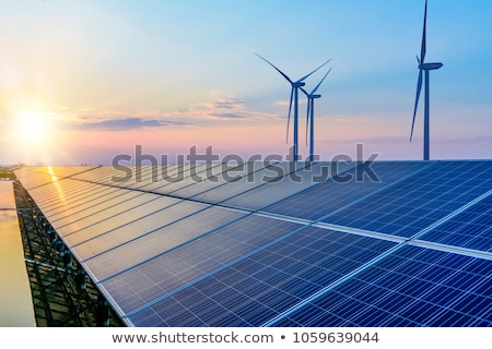 [[stock_photo]]: Solar Panels And Wind Turbines With City