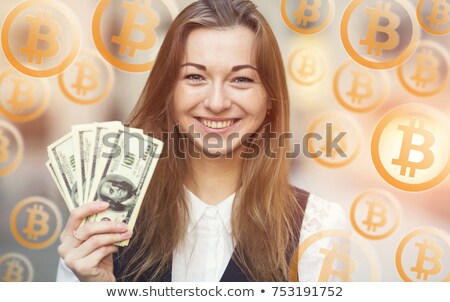 [[stock_photo]]: Cheerful Woman Holding A Bitcoin Or Bitcoin Cash