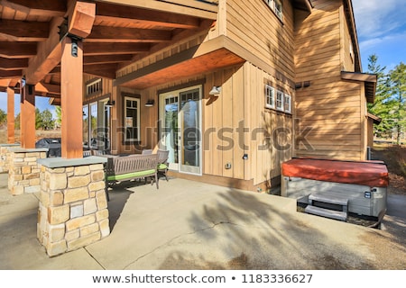 Foto stock: Home Exterior With Spacious Back Patio Hot Tub And Barbecue