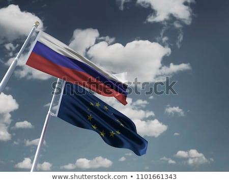 Сток-фото: Flagpoles With European Union And Ukraine Flags On Blue Sky Back