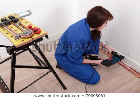 Zdjęcia stock: Female Plumber Installing Hot And Cold Water Pipes