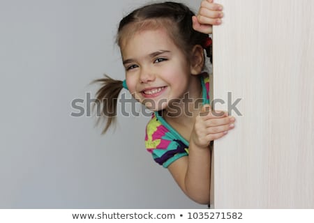 Foto d'archivio: Little Girl Behind Blank Whiteboard